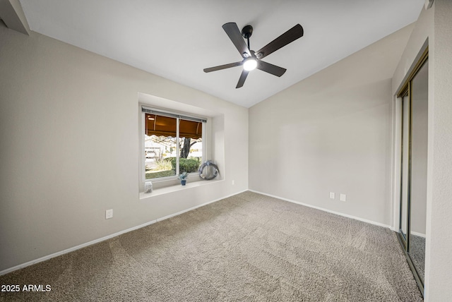 unfurnished bedroom with ceiling fan, a closet, lofted ceiling, and carpet flooring