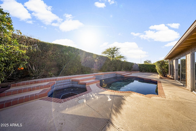 view of swimming pool featuring an in ground hot tub, a mountain view, and a patio