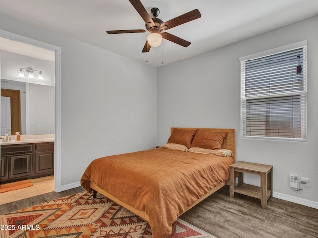 4132 W Tunnel Mine Rd, New River, AZ 85087 - bedroom with light wood finished floors, baseboards, connected bathroom, and ceiling fan