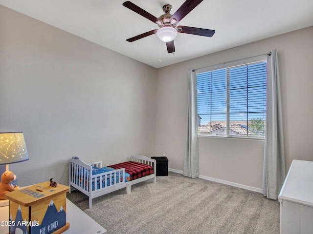 4132 W Tunnel Mine Rd, New River, AZ 85087 - bedroom featuring a nursery area, baseboards, carpet, and ceiling fan