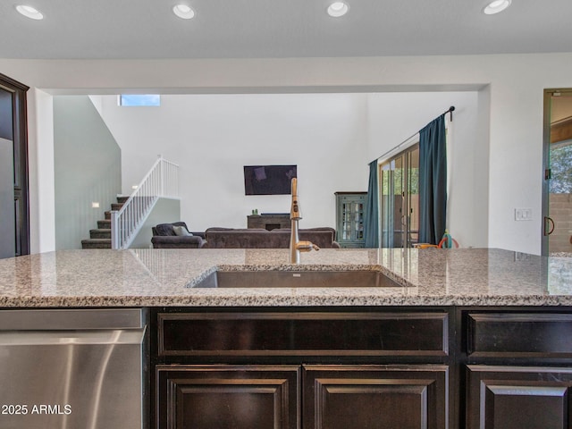 4132 W Tunnel Mine Rd, New River, AZ 85087 - kitchen featuring stainless steel dishwasher, a sink, open floor plan, light stone countertops, and recessed lighting