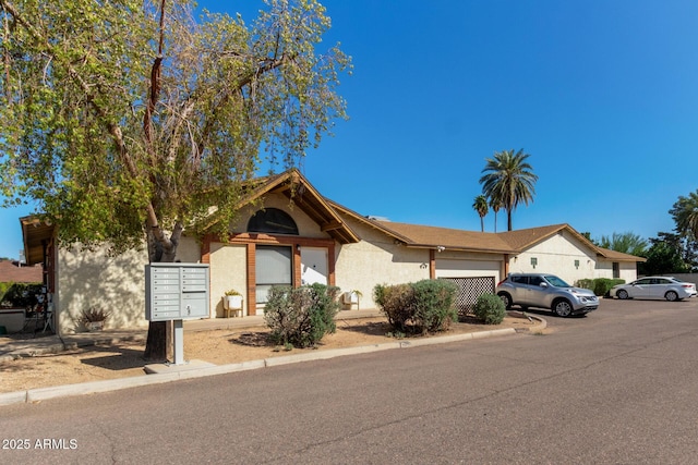 view of front of home with a garage and stucco siding
