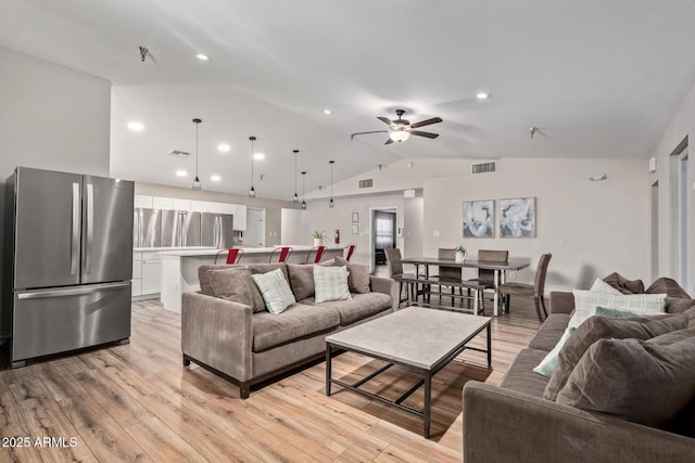 living area featuring vaulted ceiling, a ceiling fan, light wood-style flooring, and recessed lighting