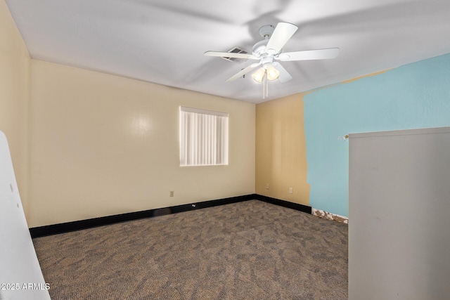 carpeted empty room featuring a ceiling fan and baseboards