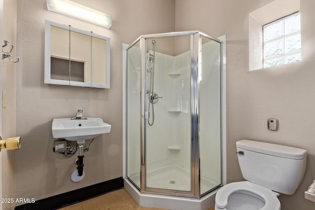 full bathroom featuring a shower stall, toilet, and tile patterned flooring