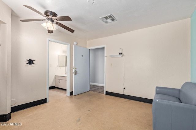 sitting room featuring ceiling fan and baseboards