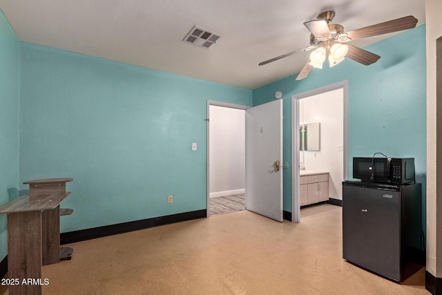 bedroom featuring light flooring, ensuite bathroom, ceiling fan, and baseboards