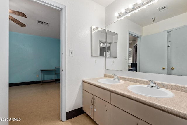 bathroom featuring double vanity, a ceiling fan, and tile patterned floors