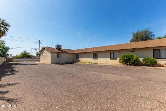 single story home featuring stucco siding and cooling unit