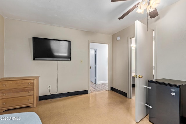 bedroom with fridge, baseboards, and a ceiling fan