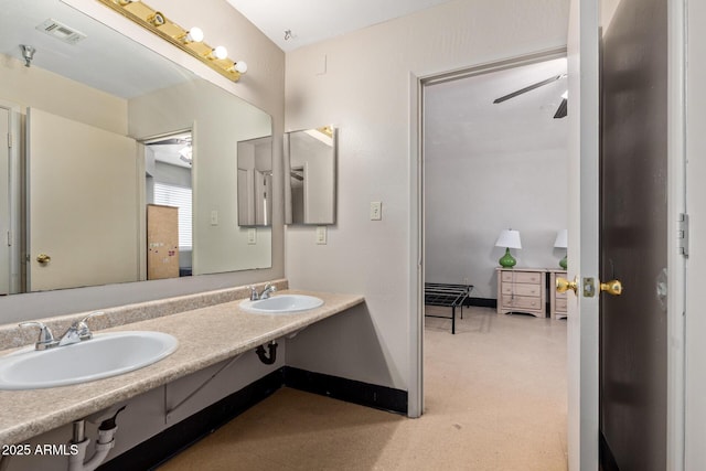 bathroom with a sink, tile patterned floors, baseboards, and a ceiling fan