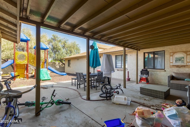 view of patio / terrace with a playground and outdoor dining area