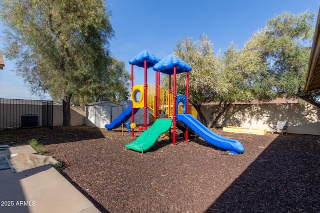 community play area featuring cooling unit and a shed