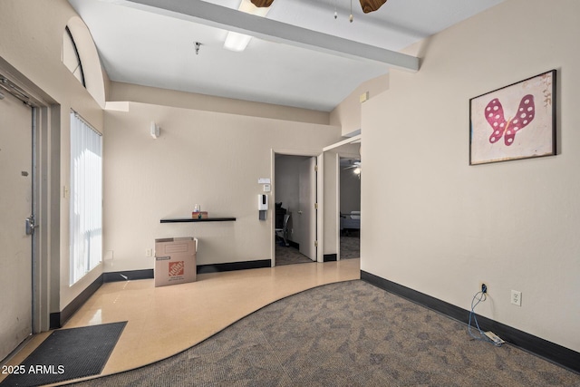 carpeted empty room featuring ceiling fan and baseboards