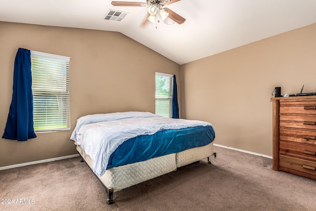 carpeted bedroom with ceiling fan and vaulted ceiling