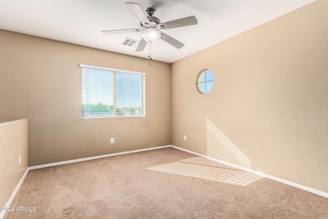 carpeted empty room featuring ceiling fan