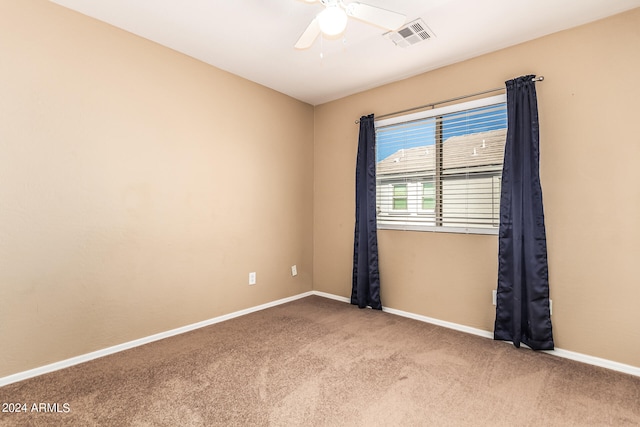 empty room featuring carpet floors and ceiling fan