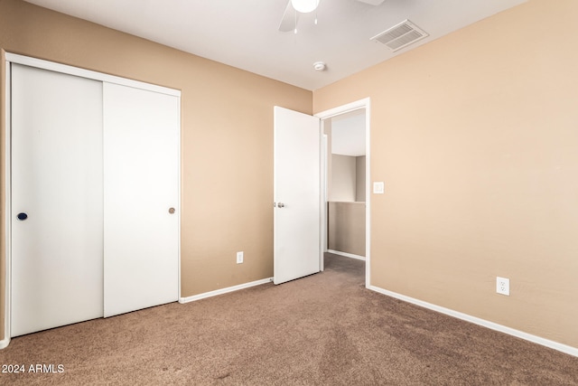 unfurnished bedroom with carpet, a closet, and ceiling fan