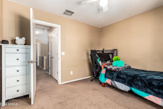 bedroom featuring ceiling fan and light carpet