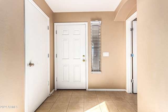 entryway with light tile patterned floors