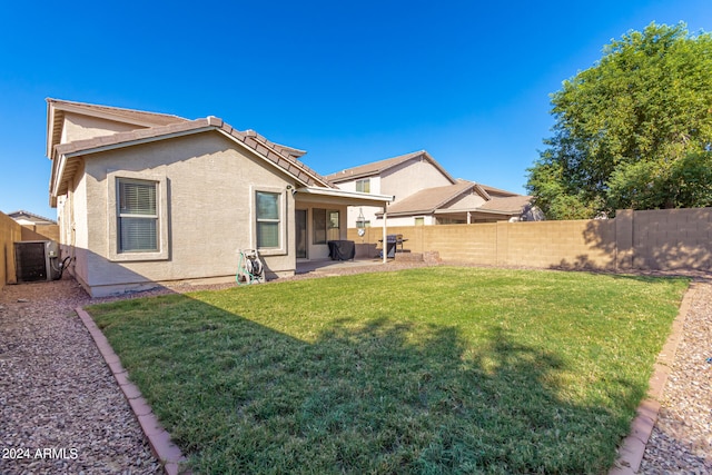 back of property with a patio area, a lawn, and cooling unit