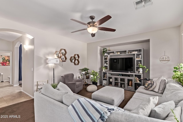 7031 W Lone Tree Trl, Peoria, AZ 85383 - living room featuring ceiling fan and arched walkways