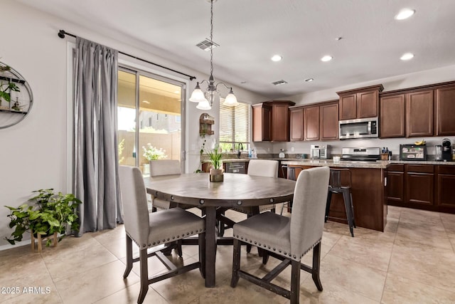7031 W Lone Tree Trl, Peoria, AZ 85383 - dining space with a chandelier, recessed lighting, and light tile patterned flooring