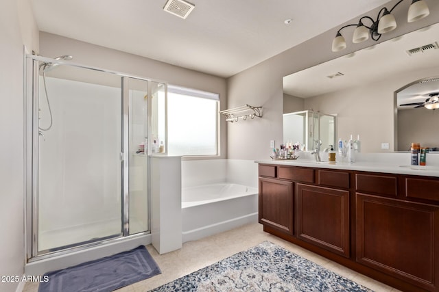 7031 W Lone Tree Trl, Peoria, AZ 85383 - bathroom featuring a shower stall, vanity, a garden tub, and ceiling fan