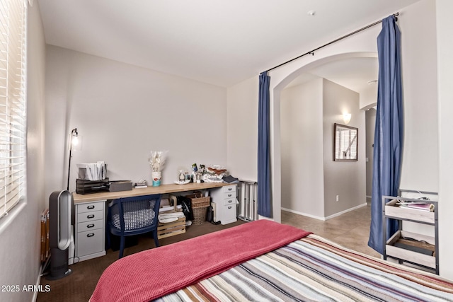 7031 W Lone Tree Trl, Peoria, AZ 85383 - bedroom featuring arched walkways and an office area