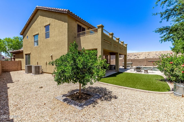 7031 W Lone Tree Trl, Peoria, AZ 85383 - rear view of house featuring a balcony, stucco siding, a patio area, and a fenced backyard