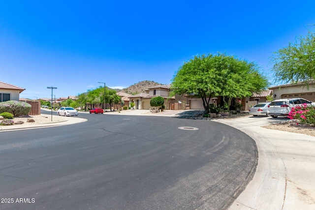 7031 W Lone Tree Trl, Peoria, AZ 85383 - view of asphalt street featuring street lights and a residential view