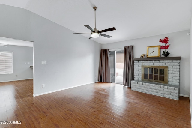 3106 S Extension Rd, Mesa, AZ 85210 - unfurnished living room with ceiling fan, vaulted ceiling, wood finished floors, a brick fireplace, and baseboards