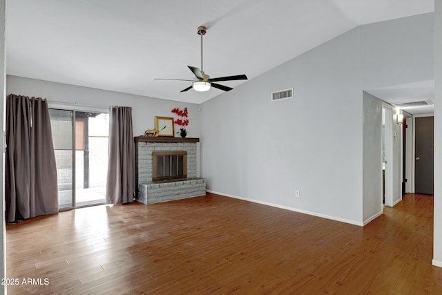 3106 S Extension Rd, Mesa, AZ 85210 - unfurnished living room with a ceiling fan, wood finished floors, a brick fireplace, baseboards, and high vaulted ceiling
