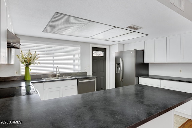 3106 S Extension Rd, Mesa, AZ 85210 - kitchen with stainless steel appliances, a sink, wall chimney range hood, and dark countertops