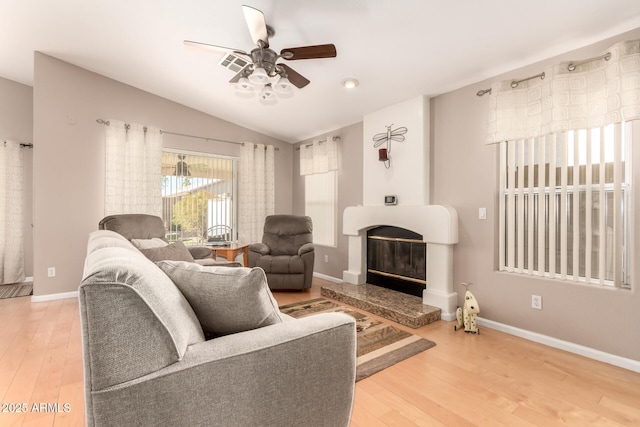 3412 E Kristal Way, Phoenix, AZ 85050 - living room with a glass covered fireplace, a ceiling fan, wood finished floors, baseboards, and lofted ceiling