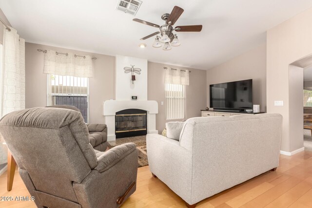 3412 E Kristal Way, Phoenix, AZ 85050 - living room with a ceiling fan, light wood-style flooring, healthy amount of natural light, a glass covered fireplace, and recessed lighting