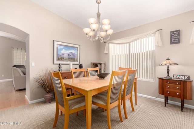 3412 E Kristal Way, Phoenix, AZ 85050 - dining area with a chandelier, baseboards, and arched walkways