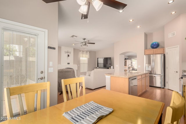 3412 E Kristal Way, Phoenix, AZ 85050 - dining area featuring ceiling fan, arched walkways, light wood-style flooring, and recessed lighting