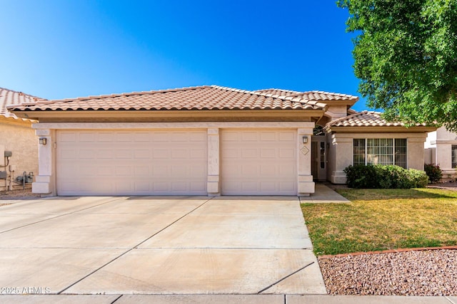3412 E Kristal Way, Phoenix, AZ 85050 - mediterranean / spanish-style home featuring driveway, stucco siding, an attached garage, and a tiled roof