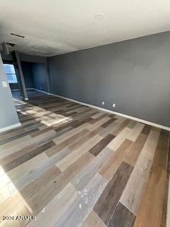 unfurnished room with wood-type flooring