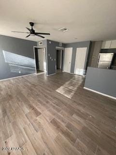 unfurnished living room with wood-type flooring and ceiling fan