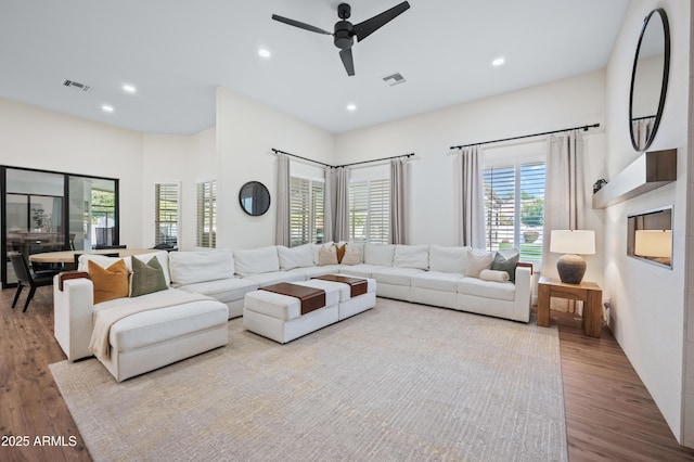 living area featuring ceiling fan, visible vents, wood finished floors, and recessed lighting