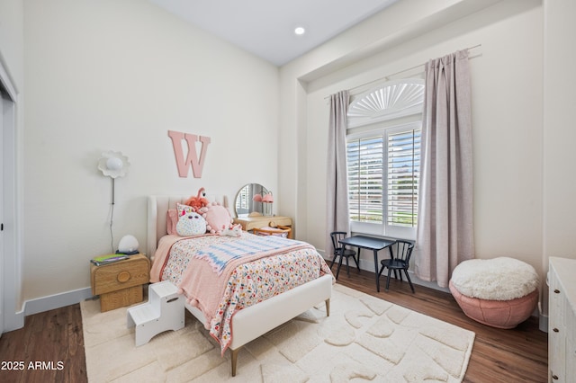 bedroom with recessed lighting, wood finished floors, and baseboards