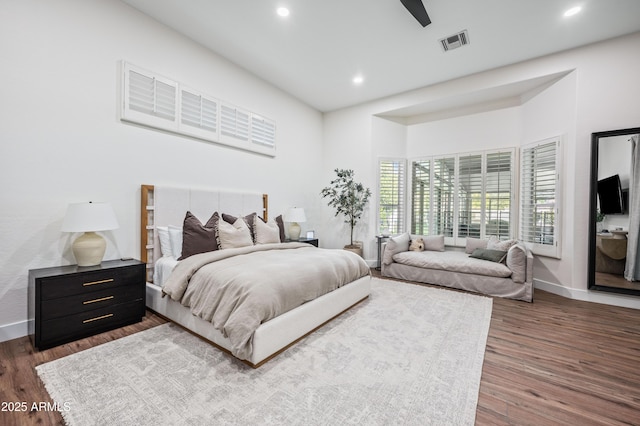 bedroom featuring visible vents, dark wood finished floors, and baseboards