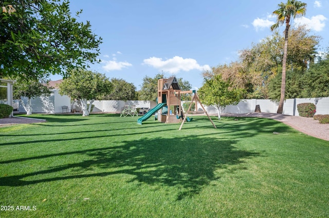 community play area featuring a fenced backyard and a yard