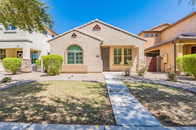 mediterranean / spanish-style home featuring a front yard