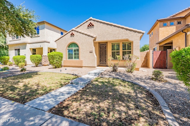 mediterranean / spanish-style home featuring a front yard