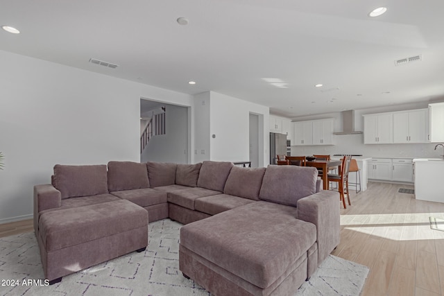 living room featuring sink and light wood-type flooring