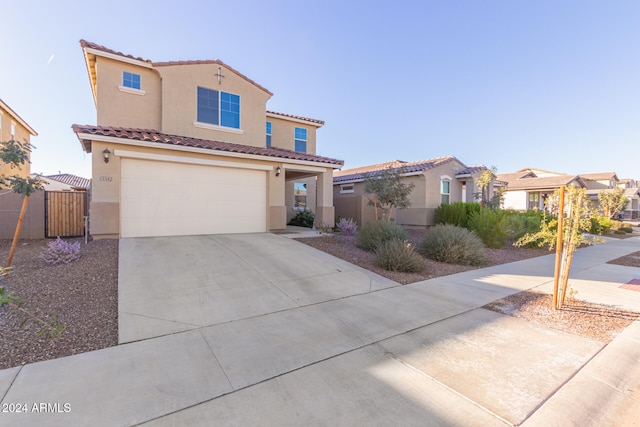 mediterranean / spanish-style home with a garage