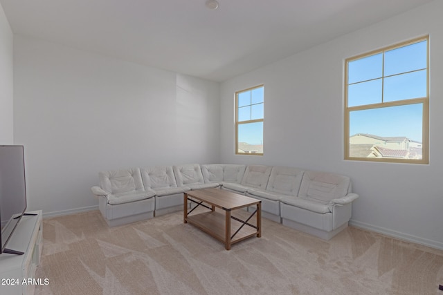 unfurnished living room featuring light carpet and a wealth of natural light